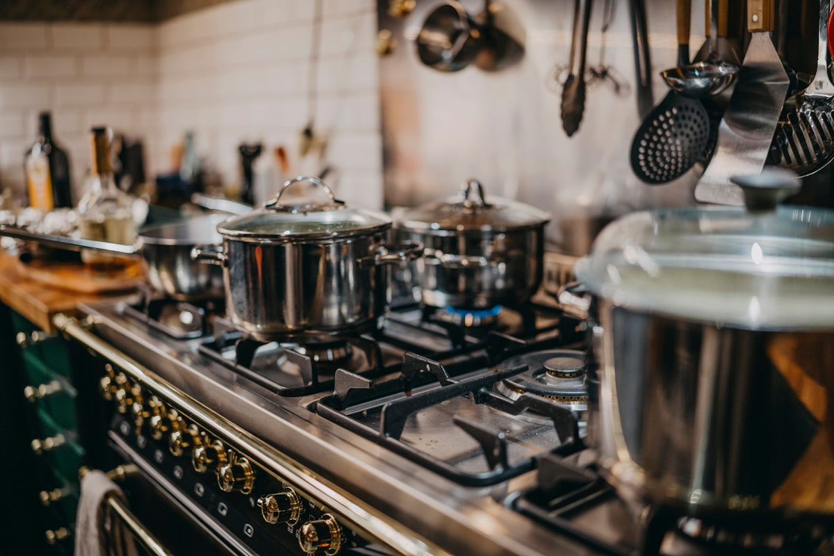 stainless steel cooking pots on gas stove