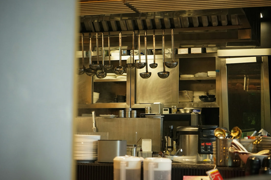 Kitchen utensils hang in a professional kitchen