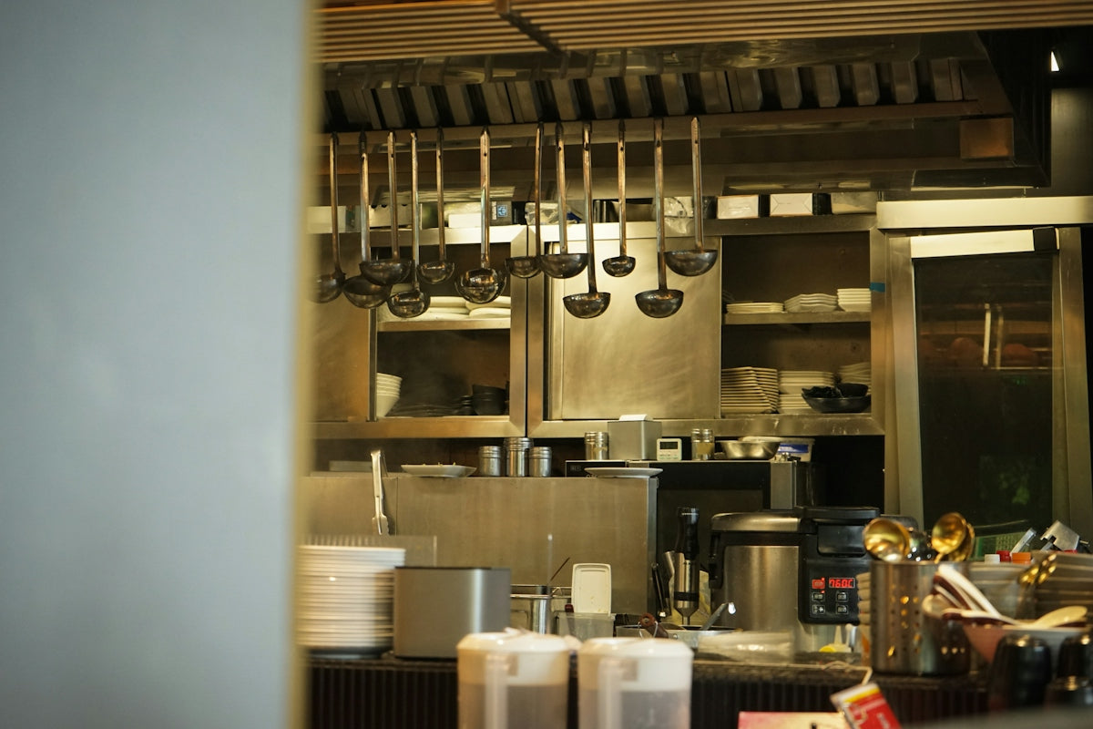 Kitchen utensils hang in a professional kitchen